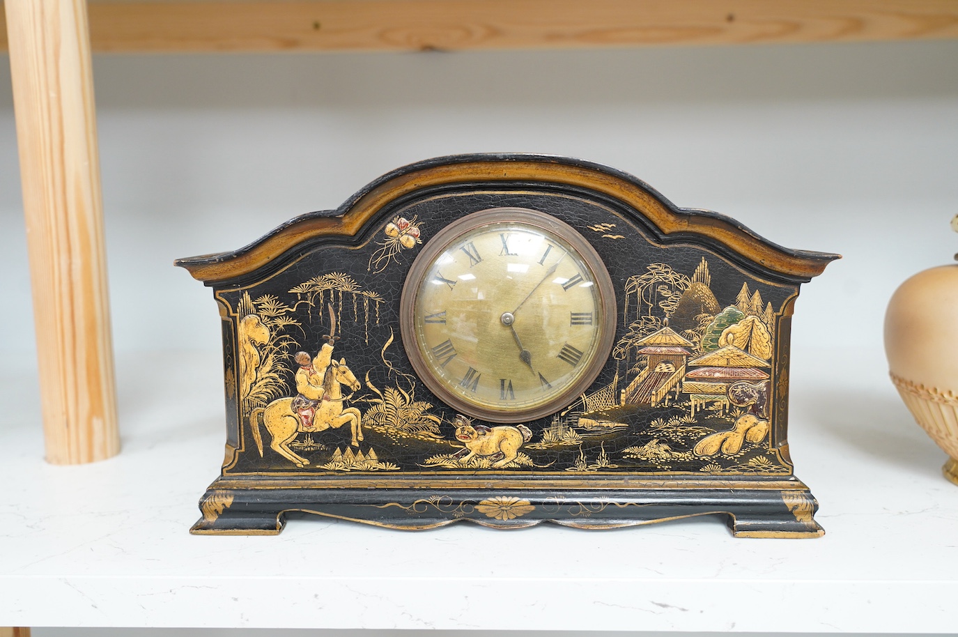 An early 20th century chinoiserie lacquer clock, 29cm wide. Condition - fair to good, currently ticking